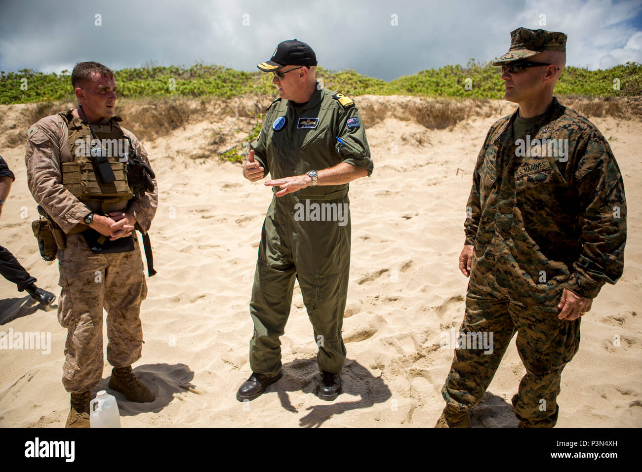 160714-M-JM737-006 MARINE CORPS BASE HAWAII (July 14, 2016) - U.S. Marine Brig. Gen. David Bellon and Royal New Zealand Navy Commodore Jim Gilmour speak to 1st Lt. Thomas Boots about the success of an Assault Amphibious Vehicle landing operation during Rim of the Pacific 2016. Bellon is the Fleet Marine Officer, Amphibious Force; Gilmour is the Combined Forces Amphibious Component Commander; Boots is an AAV Platoon Commander with Combat Assault Company, 3rd Marine Regiment. Twenty-six nations, 49 ships, six submarines, about 200 aircraft, and 25,000 personnel are participating in RIMPAC 16 fro Stock Photo