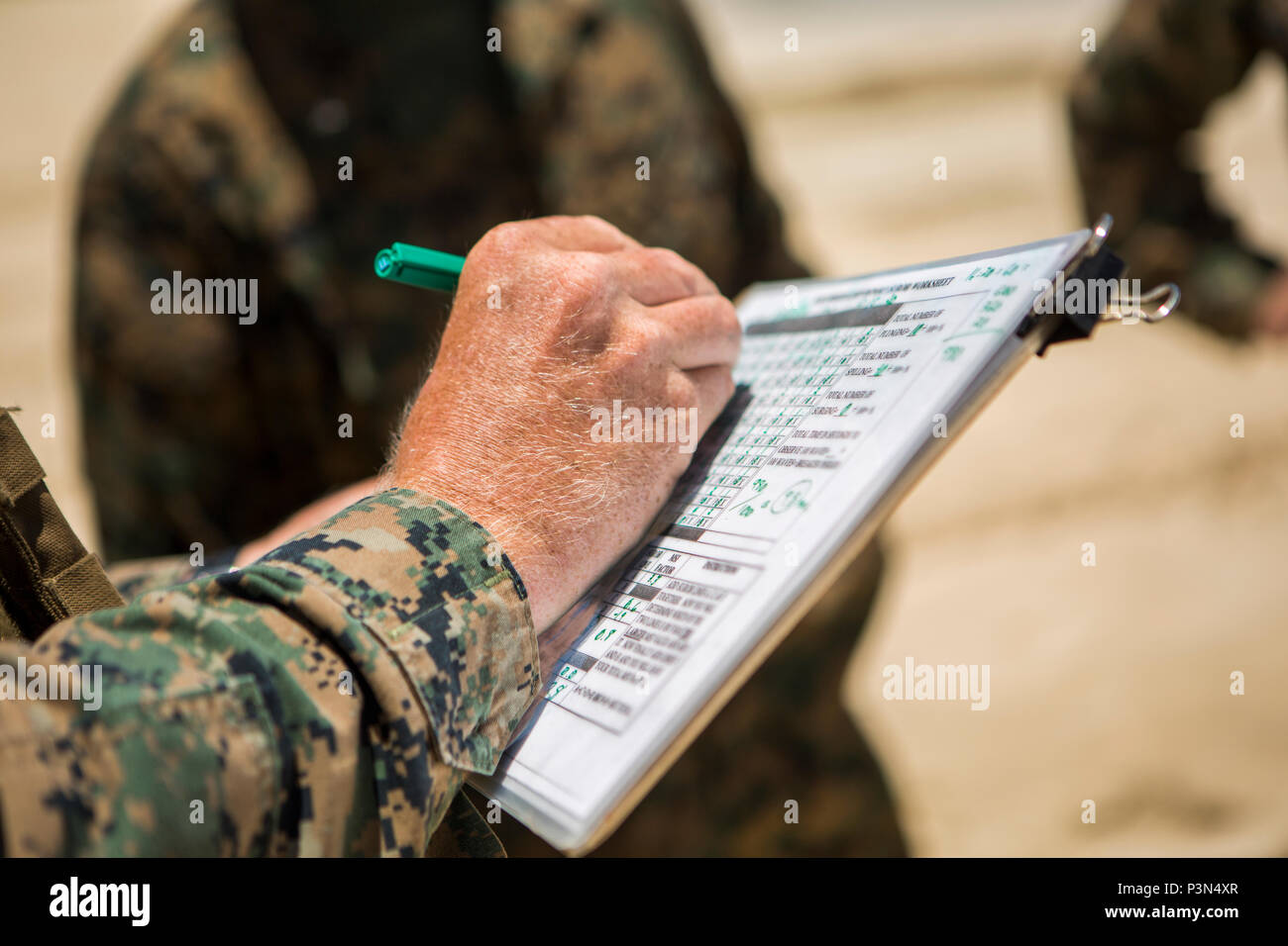 160714-M-JM737-008 MARINE CORPS BASE HAWAII (July 14, 2016) - Staff Sgt. Kyle Nicholson verifies the data he collected as Assault Amphibious Vehicles with Combat Assault Company, 3rd Marine Regiment came ashore during Rim of the Pacific 2016.  Twenty-six nations, 49 ships, six submarines, about 200 aircraft, and 25,000 personnel are participating in RIMPAC 16 from June 29 to Aug. 4 in and around the Hawaiian Islands and Southern California. The world’s largest international maritime exercise, RIMPAC provides a unique training opportunity while fostering and sustaining cooperative relationships Stock Photo