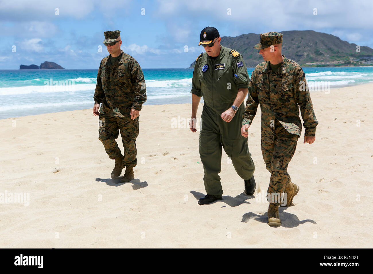 160714-M-JM737-009 MARINE CORPS BASE HAWAII (July 14, 2016) - U.S. Marine Brig. Gen. David Bellon, Royal New Zealand Navy Commodore Jim Gilmour and U.S. Marine Col. Carl Cooper move to observe U.S. Marines from Combat Assault Company, 3rd Marine Regiment and members of the Japan Ground Self-Defense Force re-embark Assault Amphibious Vehicles during Exercise Rim of the Pacific 2016. Bellon is the Fleet Marine Officer, Amphibious Force; Gilmour is the Combined Forces Amphibious Component Commander, Cooper is the Commanding Officer, Provisional Marine Expeditionary Brigade Hawaii. Twenty-six nati Stock Photo
