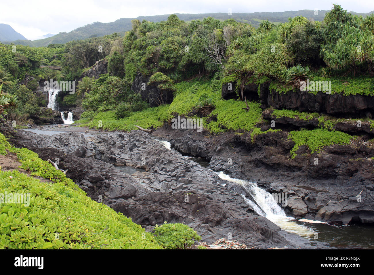 Dramatic series of waterfalls of Ohe'o Gulch cascading down a rocky under a bridge, in Haleakala National Park, Kipahula, Maui, Hawaii, USA Stock Photo