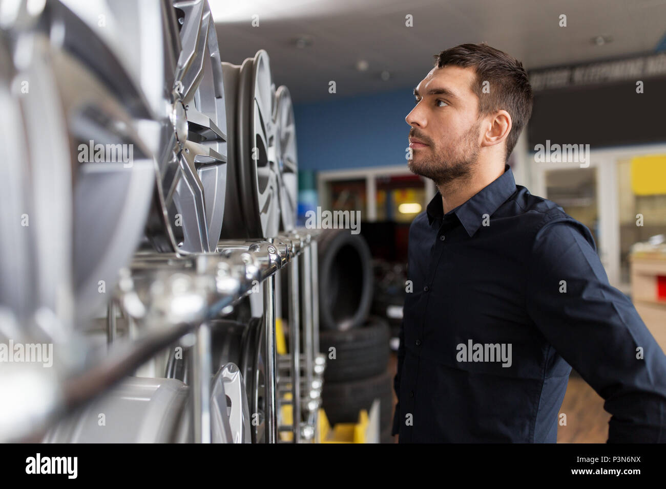Man looking at car rims hi-res stock photography and images - Alamy