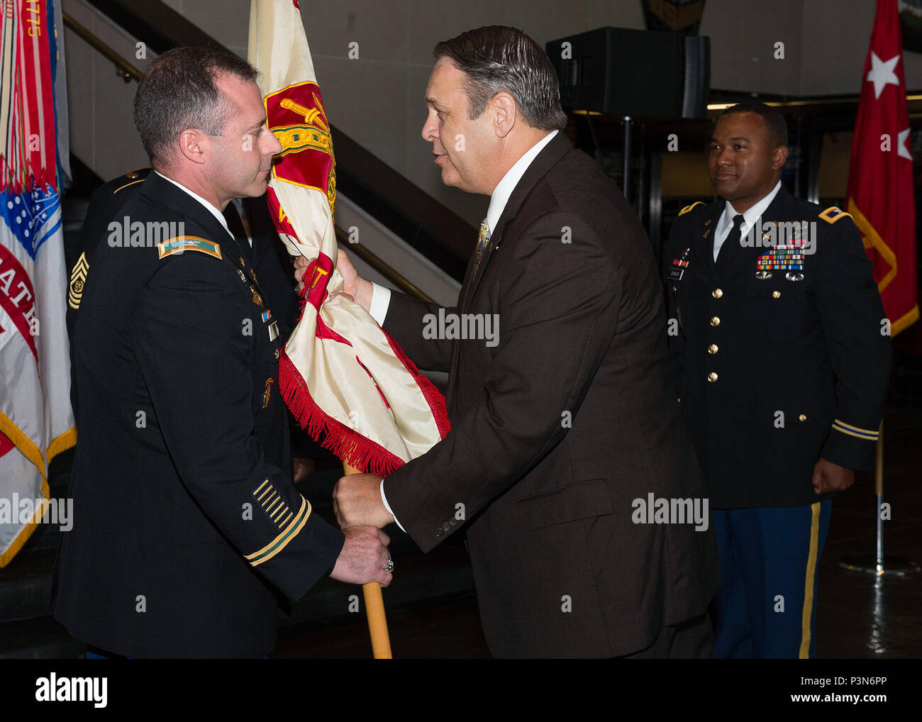 Col. Andrew S. Hanson (left) receives the U.S. Army Garrison - West Point  colors from Mr. Davis Tindoll, Director of U.S. Army Installation  Management Command - Atlantic, at Eisenhower Hall in West