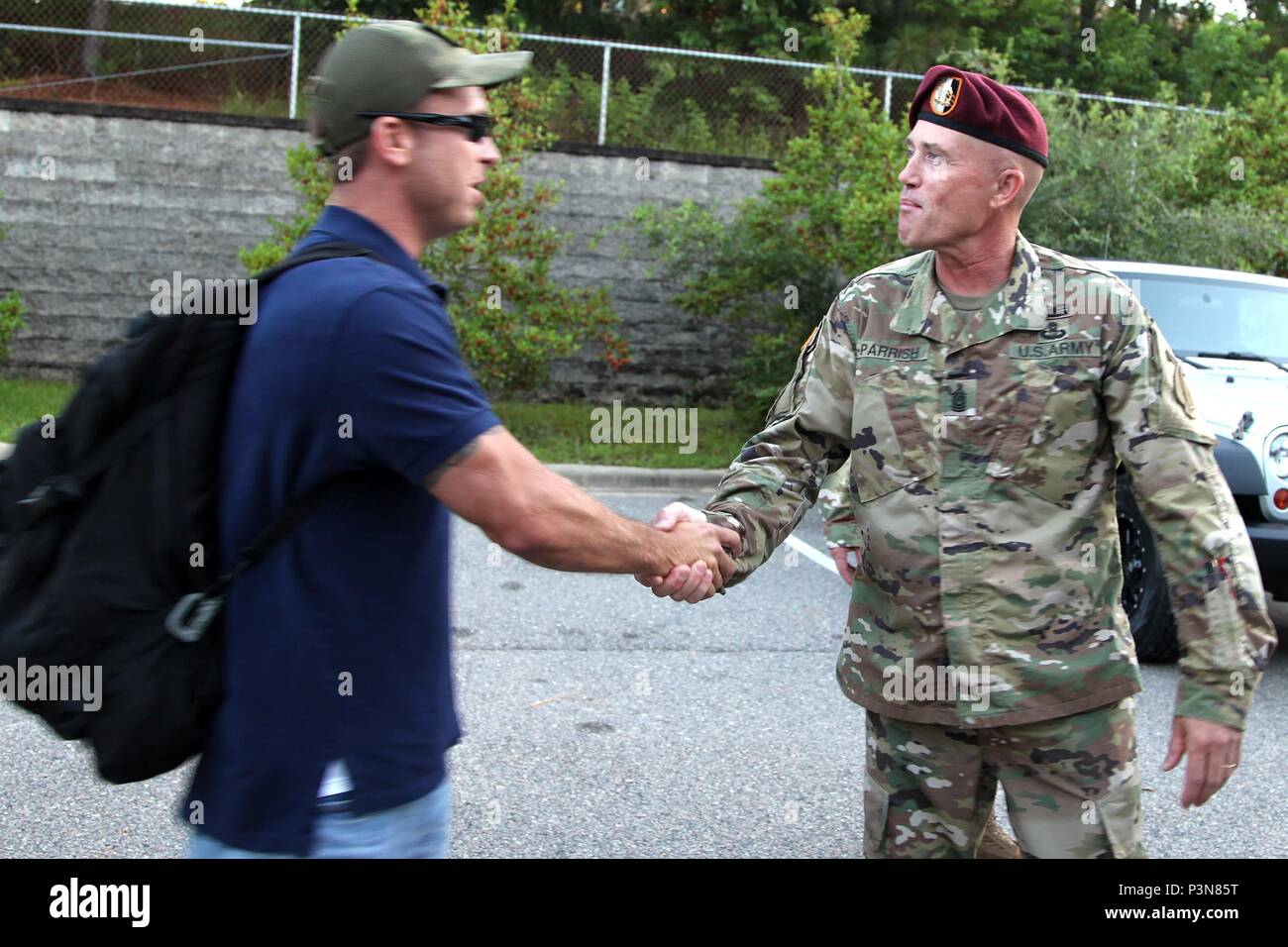 Command Sgt. Major Michael Parrish (right), senior enlisted advisor of 4th Military Information Support Group, shakes hands with a Paratrooper during a redeployment ceremony, July 8. About 60 Soldiers assigned to 4th MISG returned from Qatar following a six-month deployment supporting U.S. Central Command missions in the area. Stock Photo
