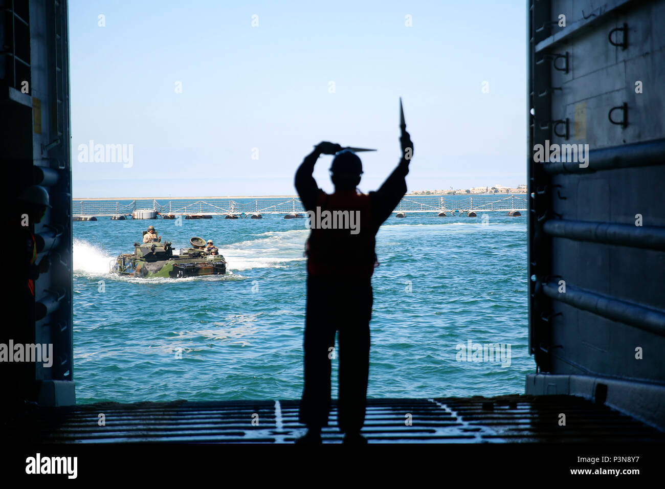 Mexican Navy 2nd Maestre CG Contramaestre Jose Antonio Morales guides a U. S. Marine amphibious assault vehicle toward the Mexican navy tank landing ship ARM Usumacinta (A-412) July 5, 2016. U.S. Marines assigned to Bravo Company, 3rd Amphibious Assault Battalion practiced AAV embarkation procedures with crewmembers of the Usumacinta (A-412) as part of the Rim of Pacific 2016 exercise.  Twenty-six nations, more than 40 ships and submarines, more than 200 aircraft and 25,000 personnel are participating in RIMPAC from June 30 to Aug. 4, in and around the Hawaiian Islands and Southern California. Stock Photo