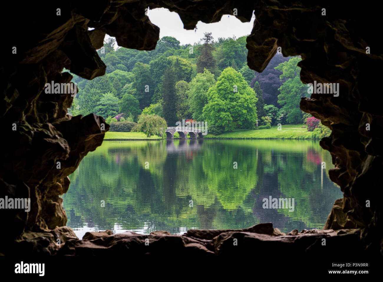 The bridge on the lake at Stourhead, as seen from the Grotto Stock Photo