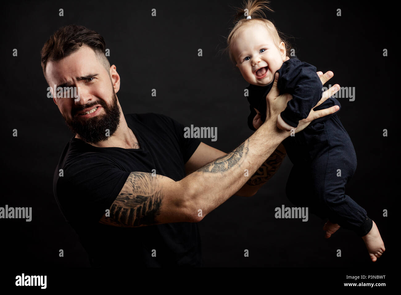 portrait of father holding on air his adorable child Stock Photo