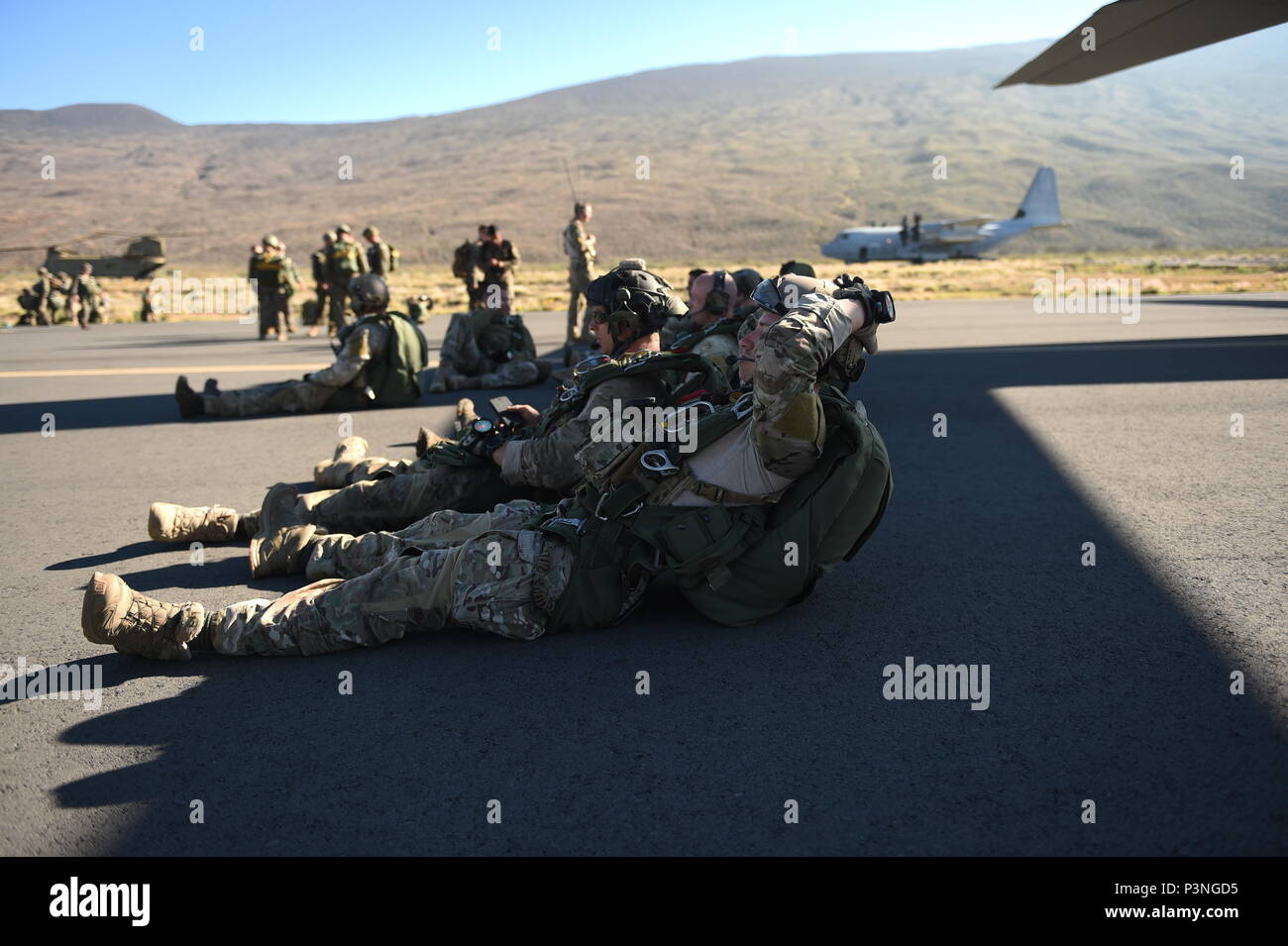 Special Tactics Airmen with the 320th Special Tactics Squadron standby to board an MC-130J Commando II to perform a military freefall operation with special operations assets and conventional forces from all four branches of the U.S. Armed Forces in a multi-aircraft, joint airborne operation as part of Rim of the Pacific 2016 to strengthen their relationships and interoperability with their partners, Pohakuloa Training Area, Hawaii, July 14, 2016. The 320th STS is participating in Rim of the Pacific 2016 with III Marine Expeditionary Force in order to practice their unique skills and strengthe Stock Photo