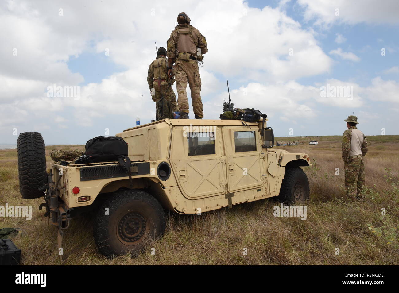 Combat controllers with the 320th Special Tactics Squadron control the air traffic during a multi-aircraft, joint airborne operation with special operations assets and conventional forces from all four branches of the U.S. Armed Forces as part of Rim of the Pacific 2016 to strengthen their relationships and interoperability with their partners, Pohakuloa Training Area, Hawaii, July 14, 2016. Twenty-six nations, more than 40 ships and submarines, more than 200 aircraft and 25,000 personnel are participating in RIMPAC from June 30 to Aug. 4, in and around the Hawaiian Islands and Southern Califo Stock Photo