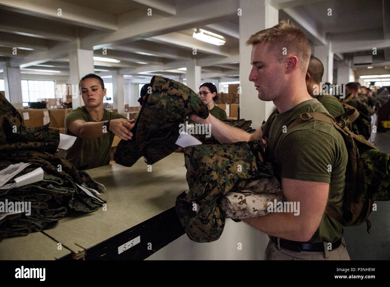 Candidates with India Company, Officer Candidate School (OCS) are issued uniform items aboard Marine Corps Base Quantico, Va., July 6, 2016. The mission of OCS is to educate and train officer candidates in order to evaluate and screen individuals for qualities required for commissioning as a Marine Corps officer. (U.S. Marine Corps Combat Camera photo by Lance Cpl. Jose Villalobosrocha/Released) Stock Photo