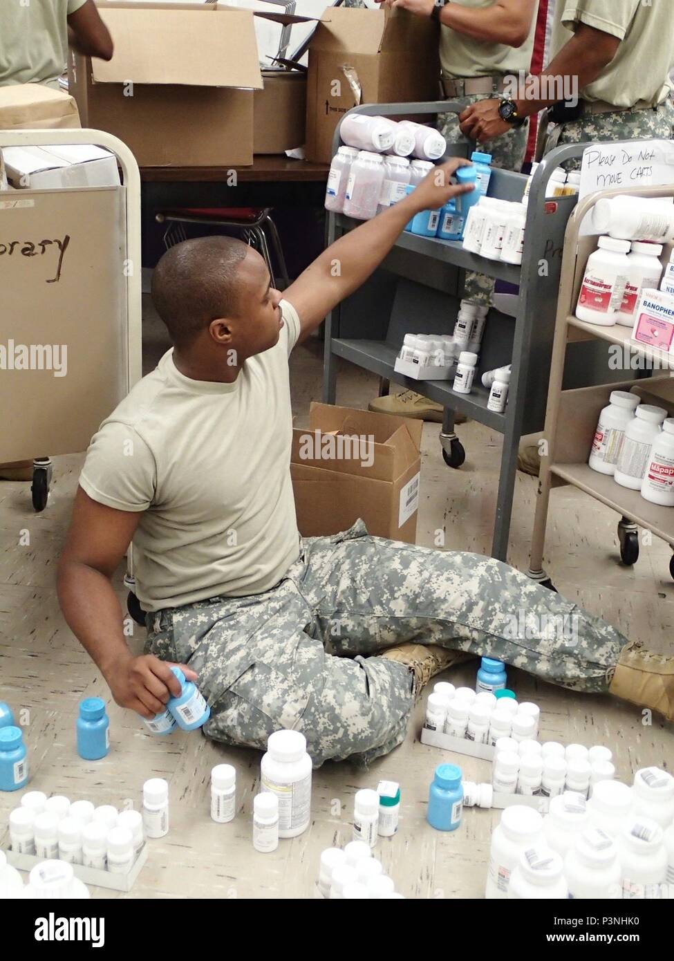 Spc. Markel Huff, a pharmacy technician from Company A, 48th Combat Support Hospital out of Fort Story, Va., helps to set up the pharmacy in preparation for Greater Chenango Cares July 14, 2016. Greater Chenango Cares is one of the Innovative Readiness Training missions which provides real-world training in a joint civil-military environment while delivering world-class medical care to the people of Chenango County, N.Y., from July 15-24. Stock Photo