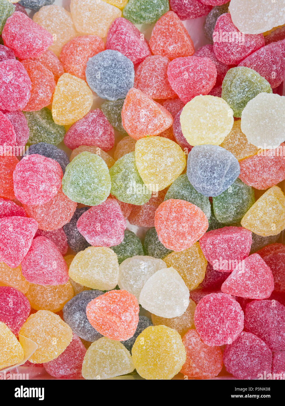 Jelly Marmalade Candies of Various Colors in Shape of Gems. Vivid Multicolored Palette Orange Yellow Green Red Pink Blue. Pattern Wallpaper Poster Ban Stock Photo