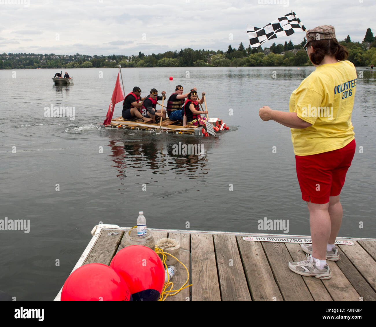 160716-N-LQ926-339 SEATTLE, Wash. (July 16, 2016) -- Marines assigned to Combat Logistics Battalion 23 out of Joint Base Lewis-McCord cross the finish line during a military race at the 2016 Albertsons/Safeway Seafair Milk Carton Derby held at the Green Lake Aqua Theater in Seattle. The event is part of the annual Seattle Seafair maritime summer celebration. (U.S. Navy photo by Mass Communication Specialist 2nd Class Alex Van’tLeven/Released) Stock Photo