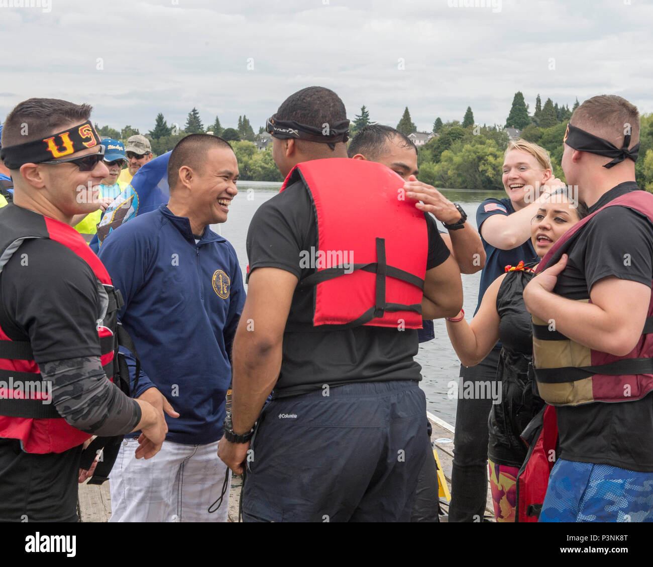 160716-N-LQ926-435 SEATTLE, Wash. (July 16, 2016) -- Sailors assigned to Navy Region Northwest and Marines from Combat Logistic Battalion 23, out of Joint Base Lewis-McCord congratulate each other after the Albertsons/Safeway Seafair Milk Carton Derby military race held at the Green Lake Aqua Theater in Seattle. The event is part of the annual Seattle Seafair maritime summer celebration. (U.S. Navy photo by Mass Communication Specialist 2nd Class Alex Van’tLeven/Released) Stock Photo