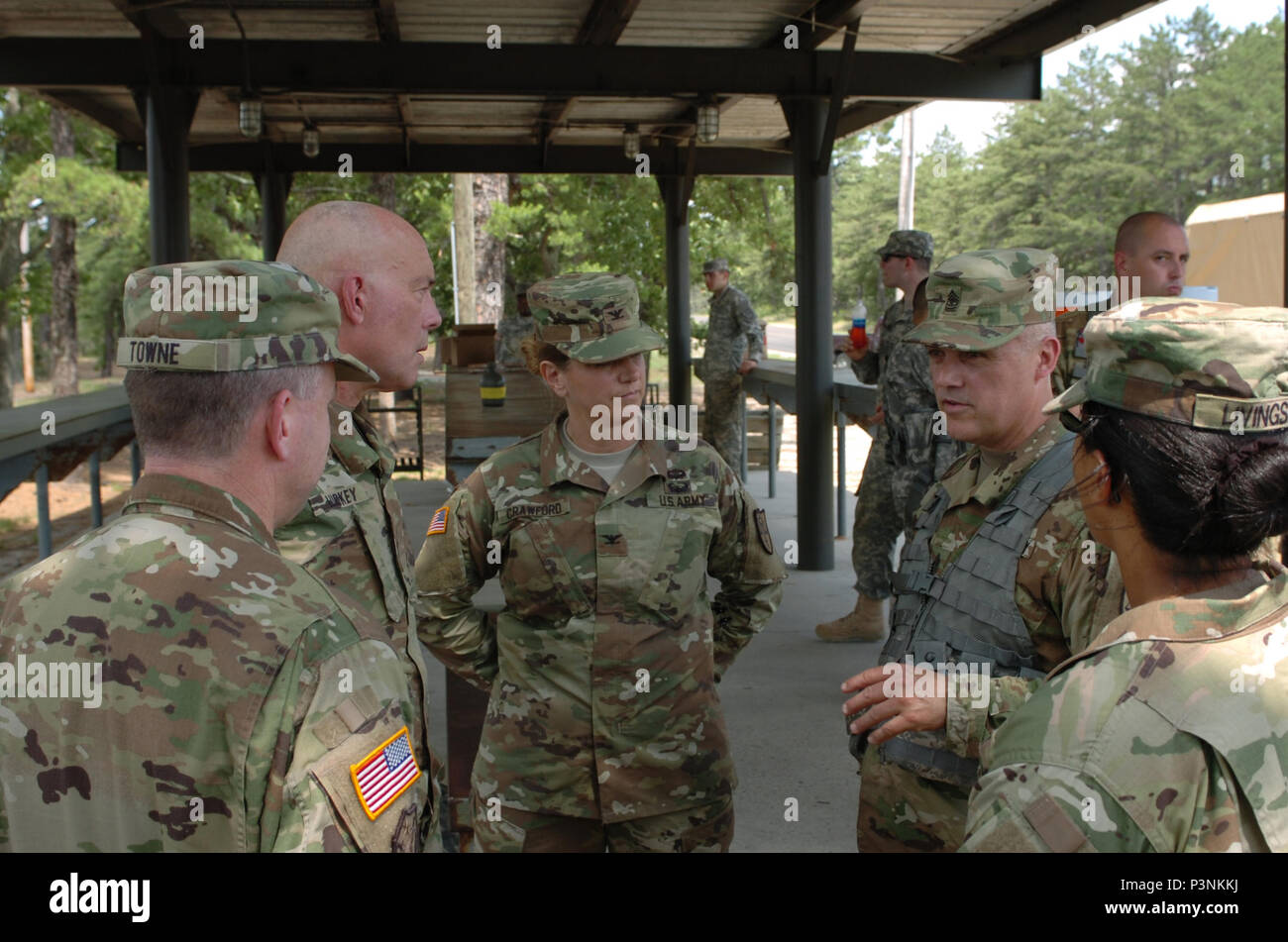 Sgt. Maj. Todd Syvrud (right), the top noncommissioned officer of the Army Reserve’s 154th Legal Operations Detachment headquartered in Alexandria, Virginia, discusses training strategies for his organization conducting range qualifications on U.S. Army Support Activity, Fort Dix ranges with Lieutenant General Charles D. Luckey, chief of Army Reserve and commanding general, U.S. Army Reserve Command, at Joint Base McGuire-Dix-Lakehurst, New Jersey, during a training-capabilities update July 14-15. Standing next to the unit's top NCO is Col. Michelle Crawford, the detachment commander. Stock Photo