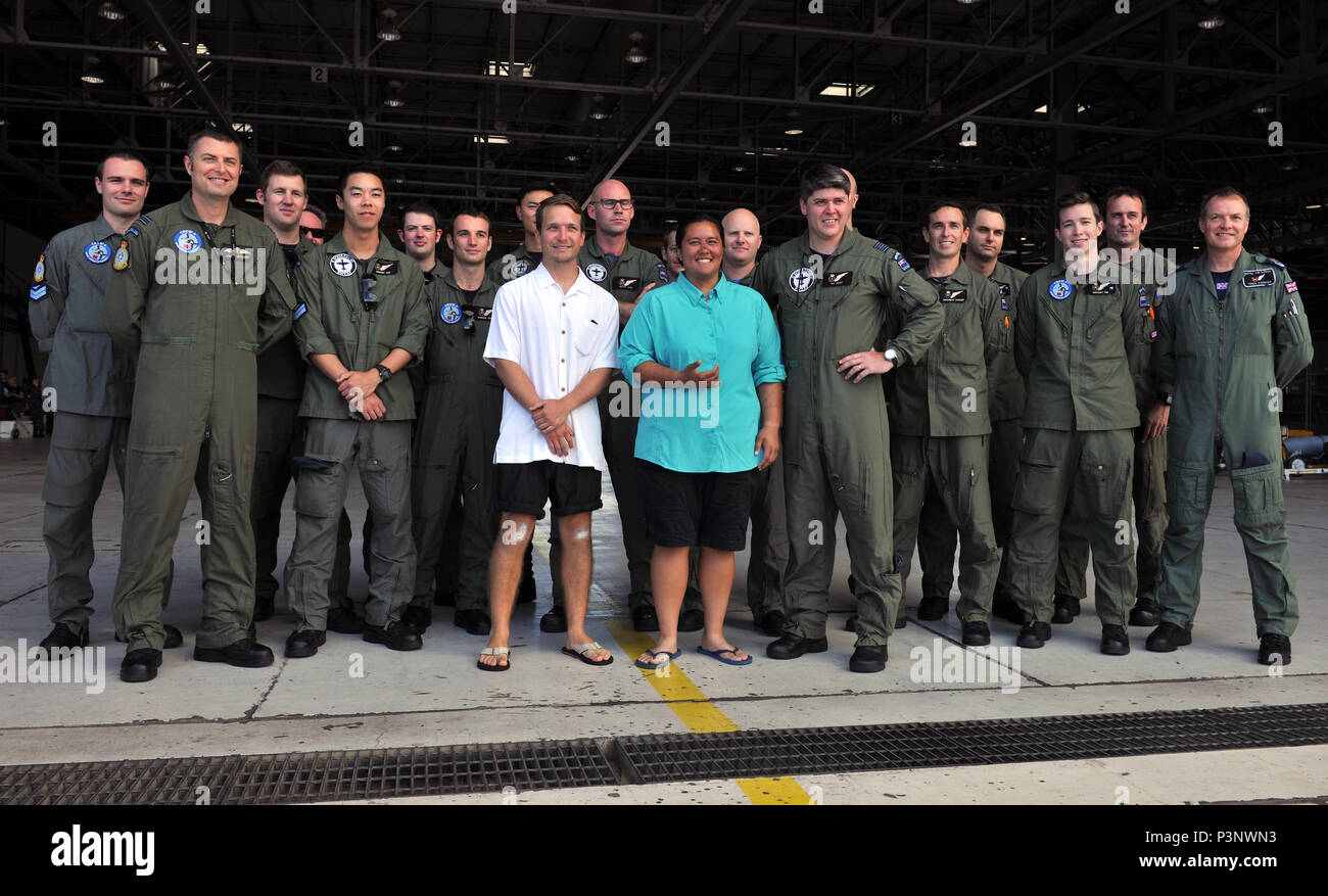 160720-N-ON468-119 MARINE CORPS BASE HAWAII (July 20, 2016) David McMahon and Sydnie Uemoto pose for a group photo with service members from the Royal New Zealand Air Force No. 5 Air Squadron at Marine Corps Base Hawaii during Rim of the Pacific 2016. David and Sydnie were involved in a small plane crash nine miles off the coast of the island of Kona, Hawaii July 15, and were rescued by a Coast Guard MH-65 Dolphin helicopter crew following an expansive joint search by U.S. Navy, Royal New Zealand Air Force, U.S. Air Force and Coast Guard crews after a 20-hour search. Twenty-six nations, more t Stock Photo