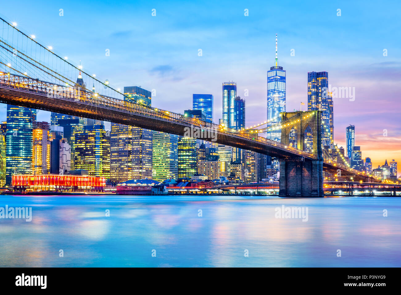 Brooklyn Bridge and the Lower Manhattan skyline at dusk Stock Photo