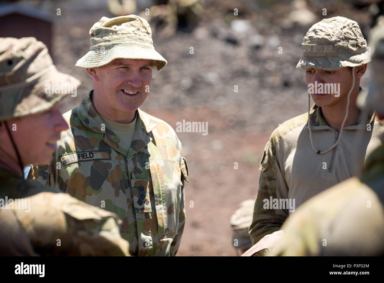 Army officer Brigadier Christopher Field left), CSC, Commander of 3rd Brigade, talks with Australian Army soldiers from 2nd Battalion, Royal Australian Regiment, at Pohakuloa training area, Hawaii, during Exercise Rim