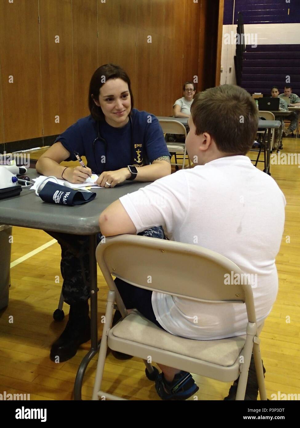 Lt. j.g. Kristen Van Meter, a nurse from Expeditionary Medical Facility Bethesda, Md., takes a patient’s information and vital signs during the Greater Chenango Cares Innovative Readiness Training event, July 21, 2016.  Greater Chenango Cares is one of the IRT events which provides real-world training in a joint civil-military environment while delivering world class, no-cost medical care to the people of Chenango County, N.Y., from July 15-24. Stock Photo