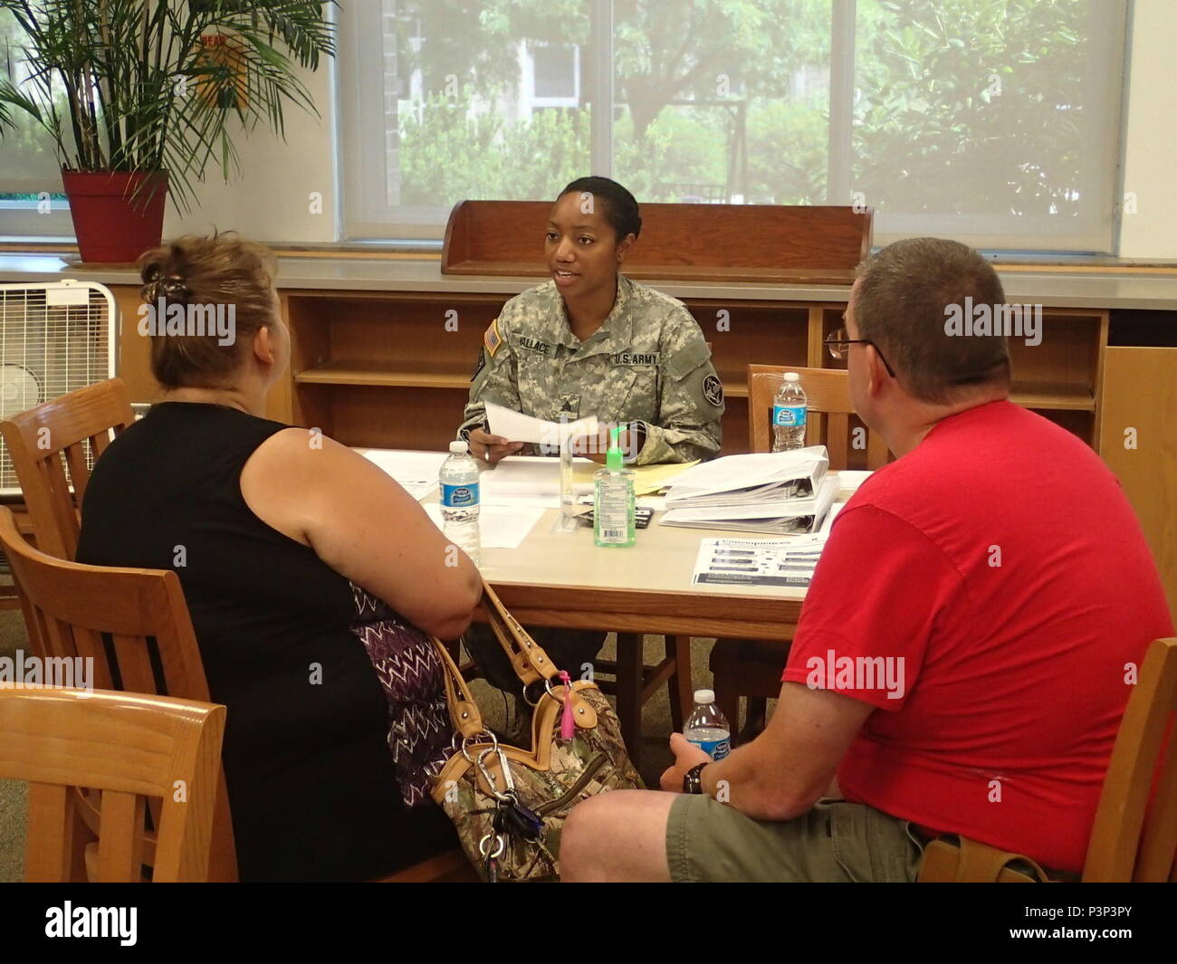 Sgt. Brittany Wallace, a healthcare specialist with Company Alpha, 48th Combat Support Hospital out of Fort Story, Va., provides patients information on continuing care during Greater Chenango Cares, July 24, 2016.  Greater Chenango Cares is one of the Innovative Readiness Training events which provides real-world training in a joint civil-military environment while delivering world-class, no-cost medical, dental, optometry and veterinary care to the people of Chenango County, N.Y., from July 15-24. Stock Photo