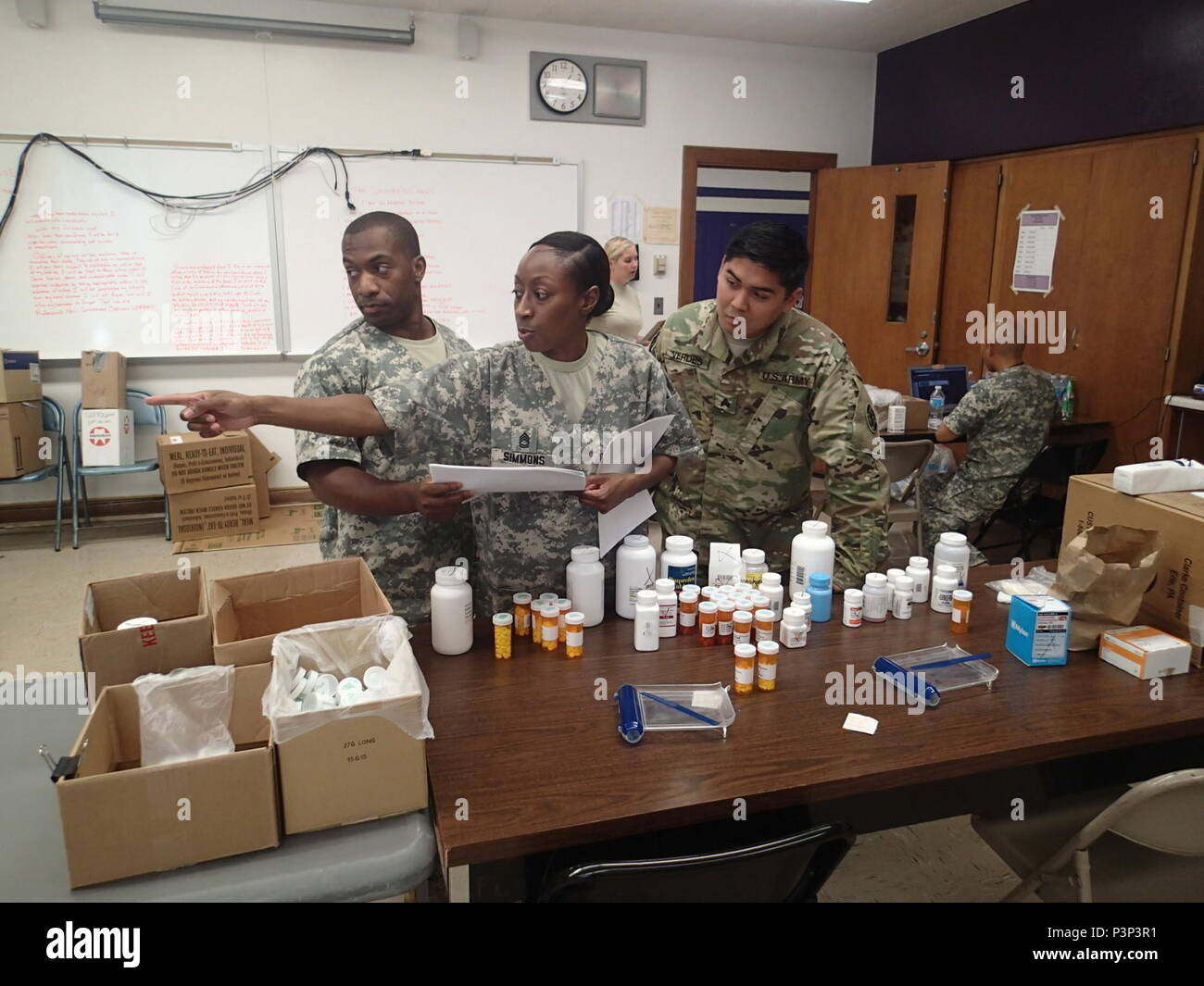 Sgt. 1st Class Carmen Simmons, a pharmacy technician, Staff Sgt. Tory Braxton, a wheeled vehicle mechanic, and Staff Sgt. Jordan Verdes, a patient administration specialist, all from Company Alpha, 48th Combat Support Hospital out of Fort Story, Va., count and log all the medications during the wrap-up of the Greater Chenango Cares Innovative Readiness Training event, July 24, 2016.  Greater Chenango Cares is one of the IRT events which provides real-world training in a joint civil-military environment while delivering world-class, no-cost medical, dental, optometry and veterinary care to the  Stock Photo