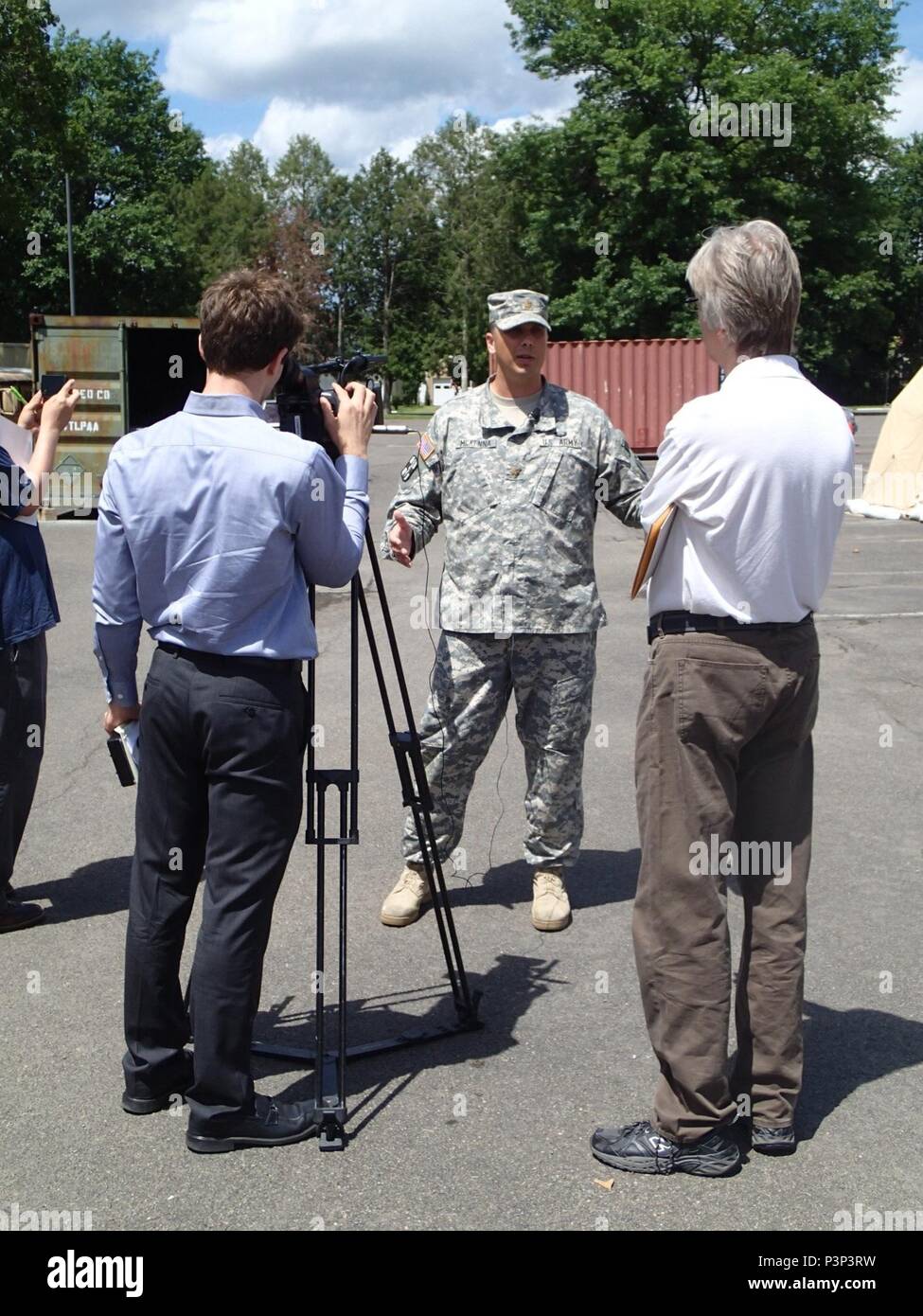 O Maj. Jeremy McKenna, mission commander from Company Alpha, 48th Combat Support Hospital out of Fort Story, Va., speaks to the media on the services provided at Greater Chenango Cares July 17, 2016. Greater Chenango Cares is one of the Innovative Readiness Training missions which provides real-world training in a joint civil-military environment while delivering world class medical care to the people of Chenango County, N.Y., from July 15-24. Stock Photo