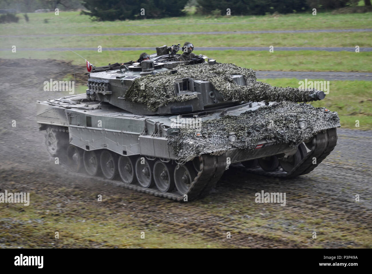 An Austrian Leopard 2A4 tank, belonging to the Bundesheer platoon, maneuvers through obstacles and terrain as part of the precision driving lane, during the Strong Europe Tank Challenge (SETC), at the 7th Army Training Command Grafenwoehr Training Area, Grafenwoehr, Germany, May 8, 2017. The SETC is co-hosted by U.S. Army Europe and the German Army, May 7-12, 2017. The competition is designed to project a dynamic presence, foster military partnership, promote interoperability, and provides an environment for sharing tactics, techniques and procedures, Platoons from six NATO and partner nations Stock Photo
