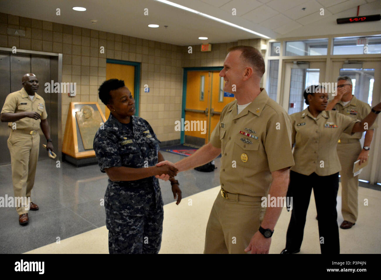 PENSACOLA, Fla. -- Naval Air Technical Training Center (NATTC) Commanding Officer Capt. Maxine Goodridge greets Master Chief Petty Officer of the Navy Steven S. Giordano May 8 aboard Naval Air Station Pensacola, Florida. Giordano toured NATTC spaces during a two-day familiarization tour of NAS Pensacola areas. Stock Photo