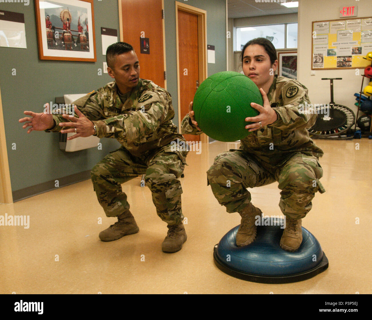 U.S. Army Capt. Allan B. Tangaan, a Davis, California, native serving as a physical therapist with the 328th Combat Support Hospital, coaches a patient on how to properly perform a stability ball exercise during a physical therapy session conducted at the Brigadier General Crawford F. Sams U.S. Army Health Clinic in Camp Zama, Japan, July 12, 2016. Tangaan and seven other Army Reserve Soldiers from the 228th CSH arrived in Japan June 24 to perform key functions that enhance Camp Zama’s health, readinesss and resiliency. These rotations offer Army Reserve Soldiers in the medical field numerous  Stock Photo