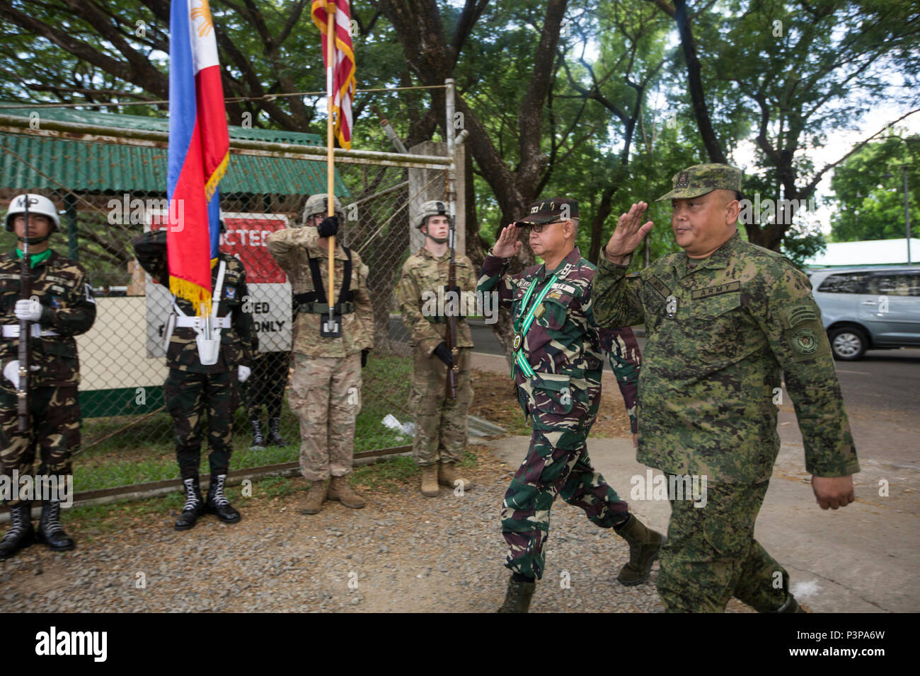 A Philippine and U.S. combined color guard greet Philippine Army Maj. Gen. Angelito De Leon, left, and Col. Laurence Mina during the opening ceremony of Balikatan 2017 at Fort Magsaysay in Santa Rosa, Nueva Ecija, May 8, 2017. De Leon is the commander of 7th Infantry Division and Mina is Deputy Assistant Chief of Staff for Training and Education Staff, Philippine Army. Balikatan is an annual U.S.-Philippine bilateral military exercise focused on a variety of missions including humanitarian and disaster relief, counterterrorism, and other combined military operations. Stock Photo