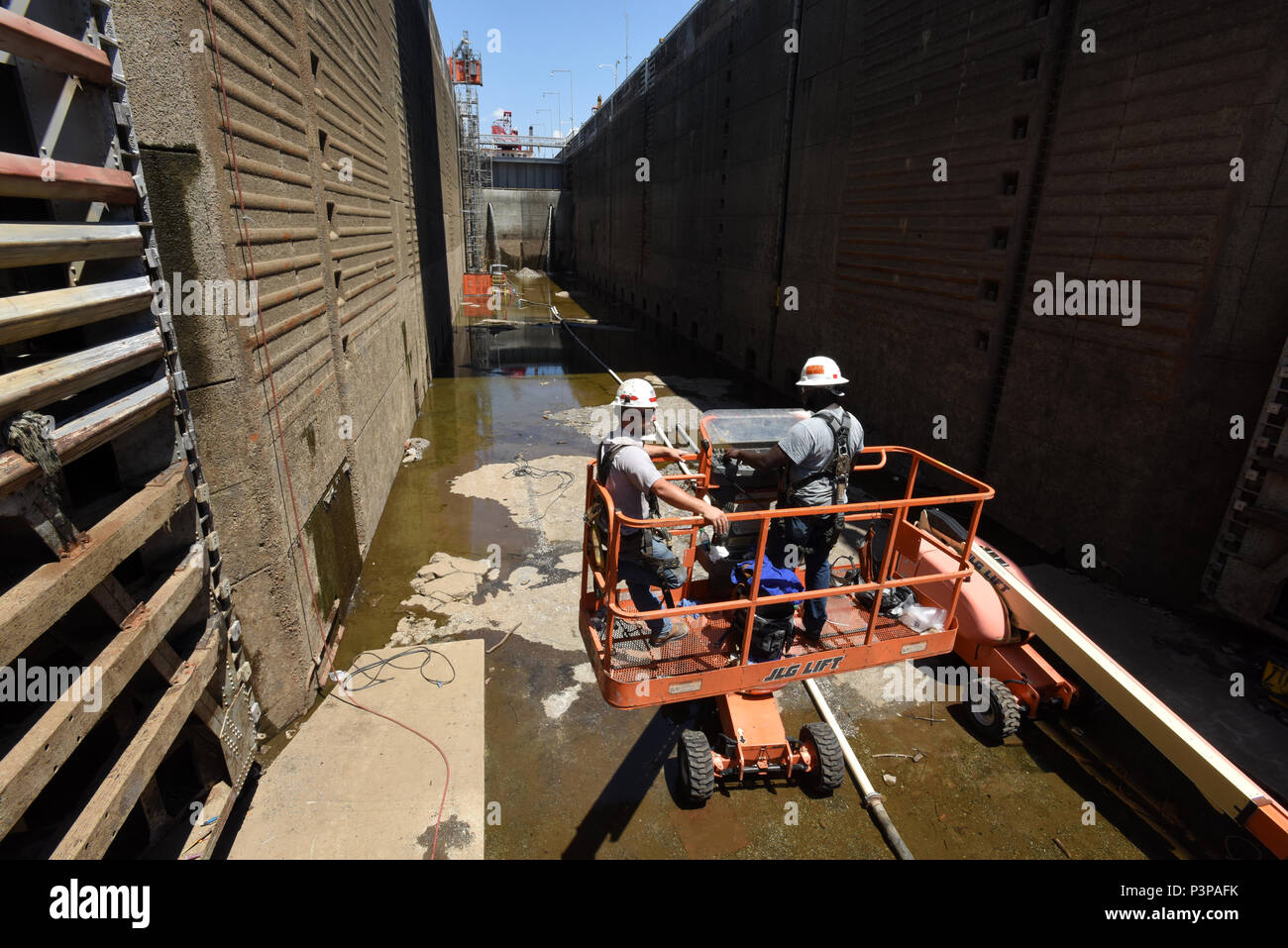 Lock and Dam Mechanics Alan Bailey (Right) and Ty Melton get into position to inspect and repair the downstream miter gate July 20, 2016 at Chickamauga Lock on the Tennessee River in Chattanooga, Tenn.  Bailey is from the Cumberland River Operations Center at Old Hickory, Tenn., and Melton is from the Tennessee River Operations Center at Florence, Ala. (USACE photo by Leon Roberts) Stock Photo