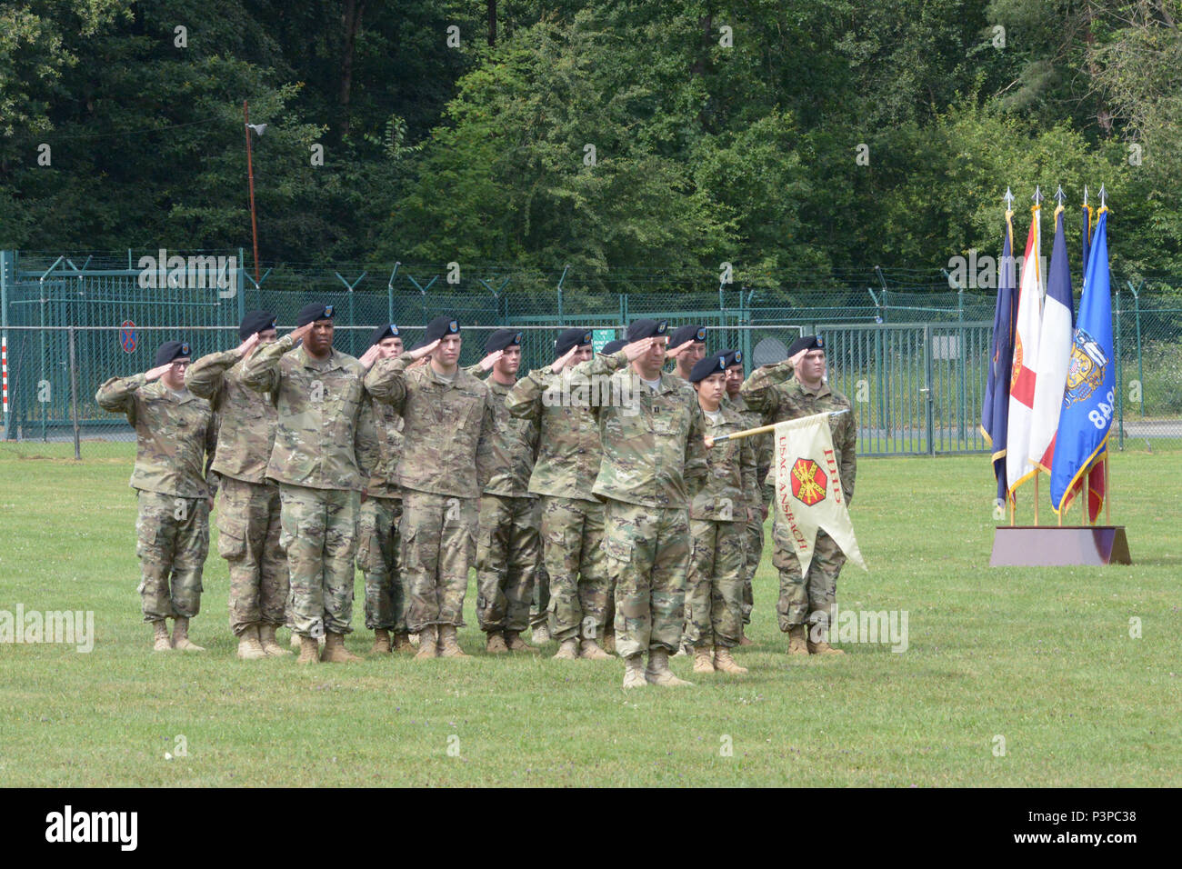 ANSBACH, Germany (July 21, 2016) – Soldiers of Headquarters and Headquarters Detachment, U.S. Army Garrison Ansbach, salute. Col. Christopher M. Benson relinquished garrison command, and Col. Benjamin C. Jones assumed command during a change of command ceremony Monday on Barton Barracks athletic field here. Stock Photo