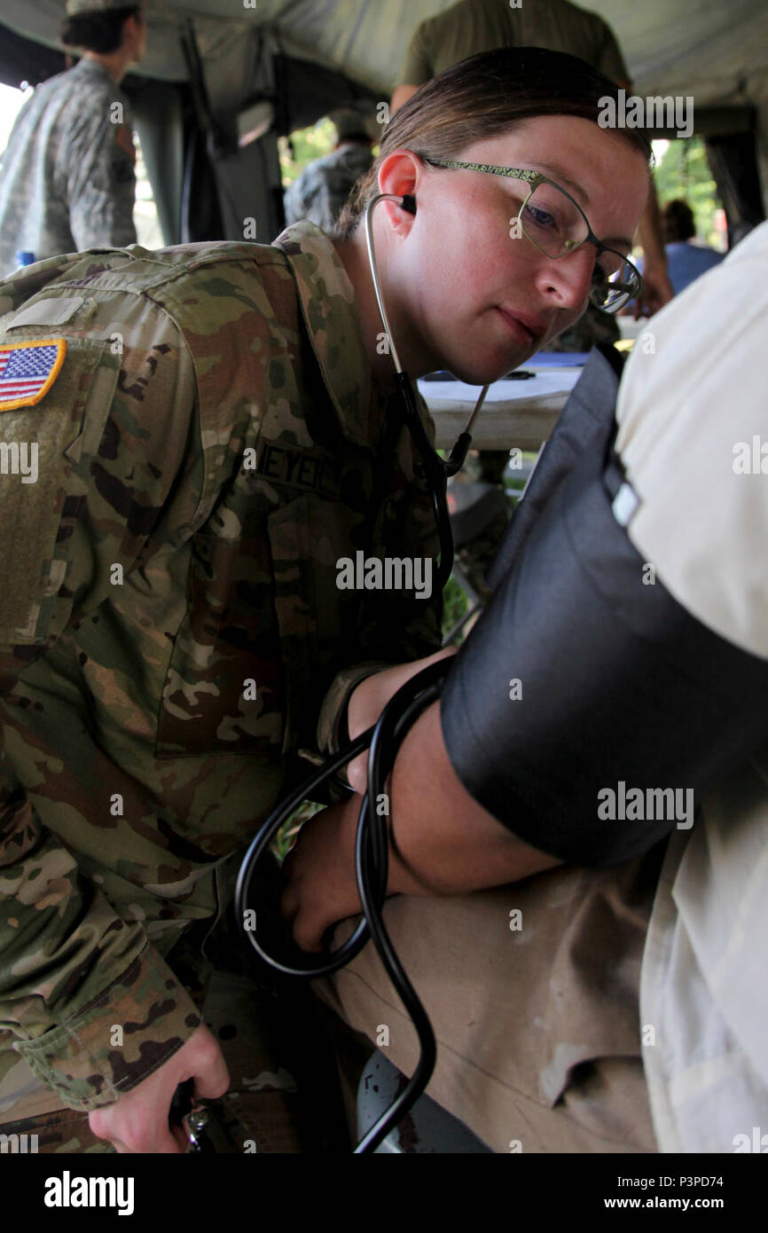 U.S. Army 2nd Lt. Danielle Meyer, with the Wyoming National Guard Medical Detachment, checks the blood pressure of a local from the San Ignacio area while in-processing her at a medical readiness event held in San Ignacio, Belize,  May 08, 2017. This is the second of three medical events that are scheduled to take place during Beyond the Horizon 2017. BTH 2017, a U.S. Southern Command-sponsored, Army South-led exercise designed to provide humanitarian and engineering services to communities in need, demonstrating U.S. support for Belize. Stock Photo