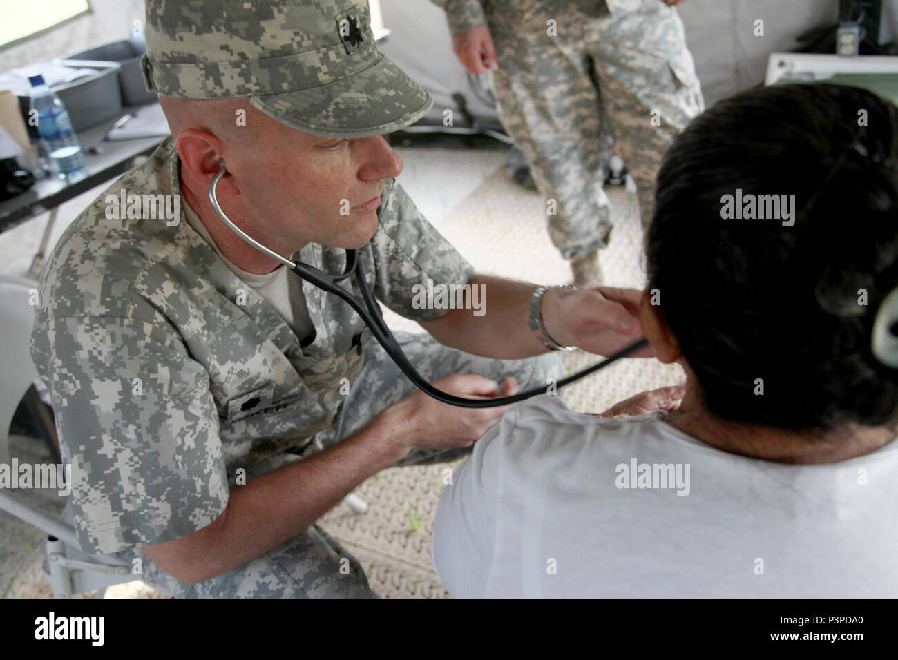 U.S. Army Lt. Col. Derrick Kooker, with the Wyoming National Guard Medical Detachment, listens to the heart beat of a Belizean local during a medical readiness event held in San Ignacio, Belize,  May 08, 2017. This is the second of three medical events that are scheduled to take place during Beyond the Horizon 2017. BTH 2017, a U.S. Southern Command-sponsored, Army South-led exercise designed to provide humanitarian and engineering services to communities in need, demonstrating U.S. support for Belize. Stock Photo