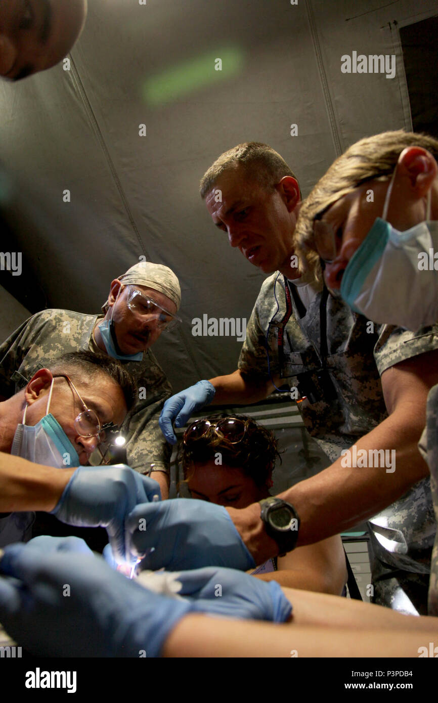 U.S. Army dental staff, with the Wyoming National Guard Medical Detachment, remove the tooth of a Belizean boy during a medical readiness event held in San Ignacio, Belize, May 08, 2017. This is the second of three medical events that are scheduled to take place during Beyond the Horizon 2017. BTH 2017 is a U.S. Southern Command-sponsored, Army South-led exercise designed to provide humanitarian and engineering services to communities in need, demonstrating U.S. support for Belize. Stock Photo