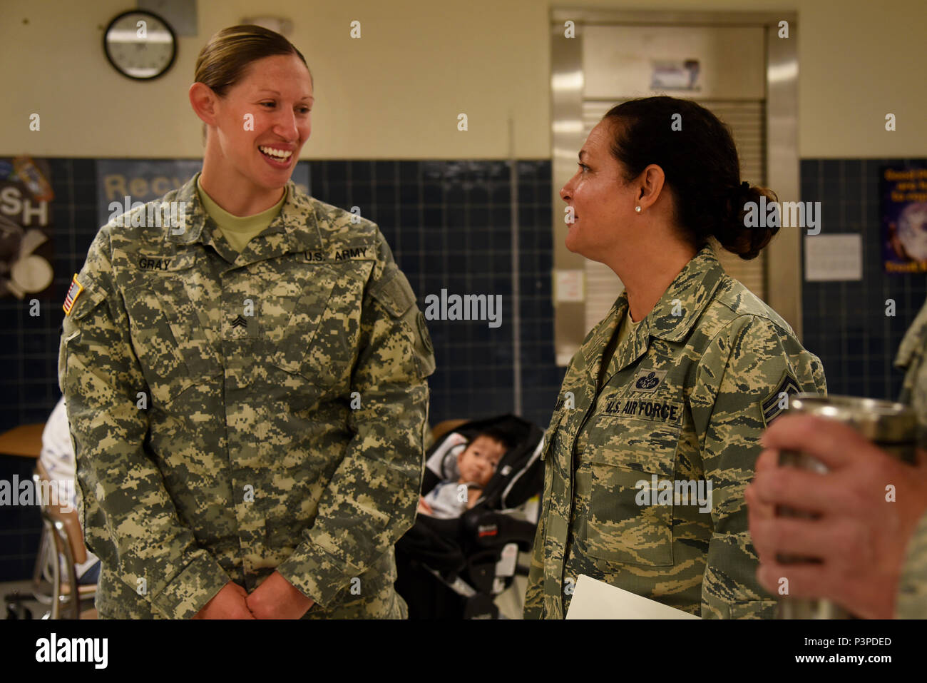 U.S. Army Sgt. Ashley Gray, 48th Combat Support Hospital, left, speaks with Command Chief Master Sgt. Janeen Fillari, New Jersey State Command Chief, during the Healthy Cortland event at Homer Intermediate School in Homer, N.Y., July 20, 2016. Service members provided no cost medical, dental, optometry, and veterinary care to local citizens. (U.S. Air National Guard photo by Senior Airman Julia Santiago) Stock Photo