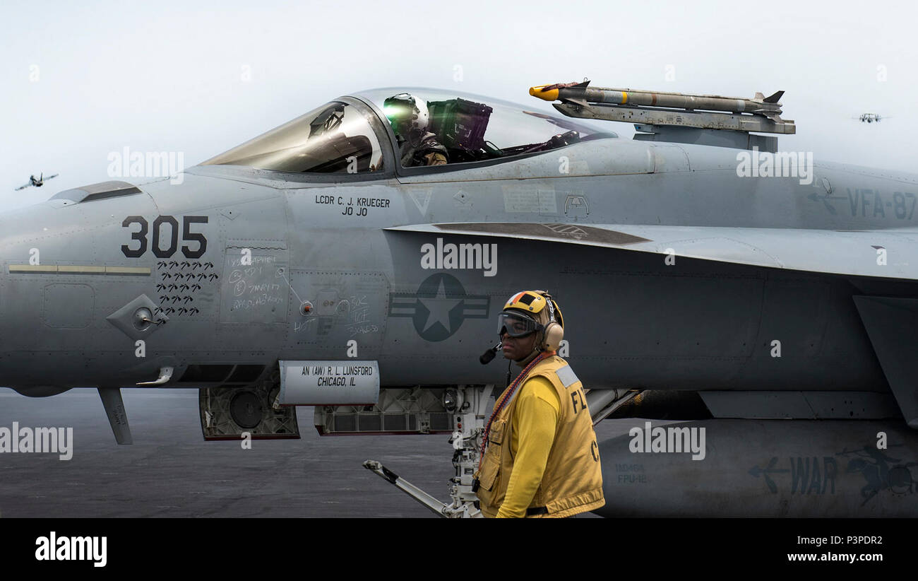 ARABIAN GULF (May 7, 2017) An F/A-18E Super Hornet attached to the 'Golden Warriors' of Strike Fighter Squadron (VFA) 87 taxis on the flight deck aboard the aircraft carrier USS George H.W. Bush (CVN 77) (GHWB). GHWB is deployed in the U.S. 5th Fleet area of operations in support of maritime security operations designed to reassure allies and partners, and preserve the freedom of navigation and the free flow of commerce in the region. Stock Photo