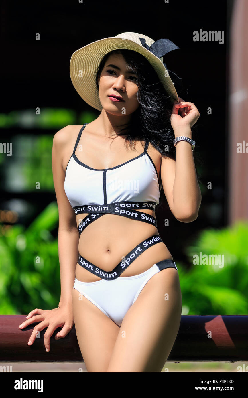 Young beautiful asian girl posing in white bikini Stock Photo - Alamy