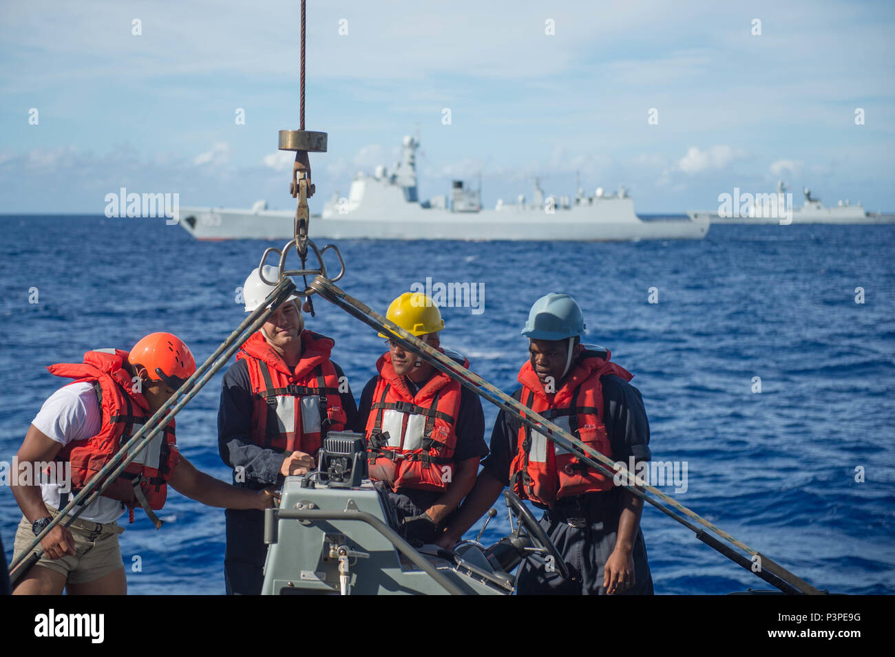 Sailors board a rigid hull inflatable boat (RHIB) from guided-missile ...