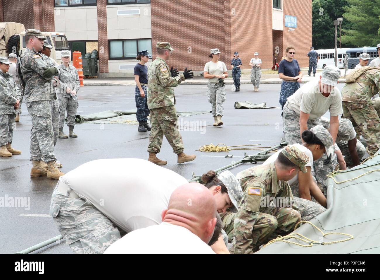 Capt. Burke Tervort, with the 48th Combat Support Hospital out of Fort Meade, Md., gives commands to service members in order to set up the veterinary hospital tents in preparation for the Healthy Cortland Innovative Readiness Training event, July 14th, 2016.  Healthy Cortland is one of the IRT events that provides real-world training in a joint civil-military environment while delivering world-class medical care to the people of Cortland County, N.Y., from July 15-24. Stock Photo