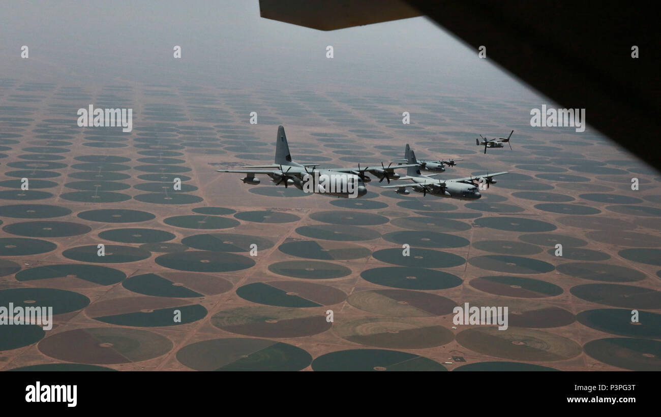 A division of U.S. Marine Corps KC-130J Super Hercules assigned to Marine Aerial Refueler Transport Squadron (VMGR) 352 and an MV-22 Osprey tiltrotor aircraft with Marine Medium Tiltrotor Squadron (VMM) 364, Special Purpose Marine Air-Ground Task Force-Crisis Response-Central Command, return from a tactical recovery of aircraft and personnel exercise in Jordan, May 8, 2017. This event supported Eager Lion 2017, a recurring multinational exercise designed to strengthen military-to-military relationships, increase interoperability between partner nations, and enhance regional security and stabil Stock Photo