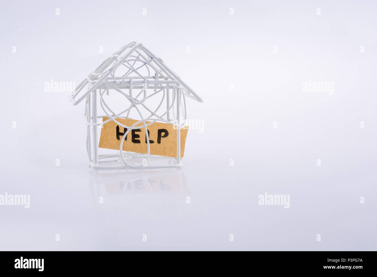 Little metal house and the word HELP on a white background Stock Photo ...