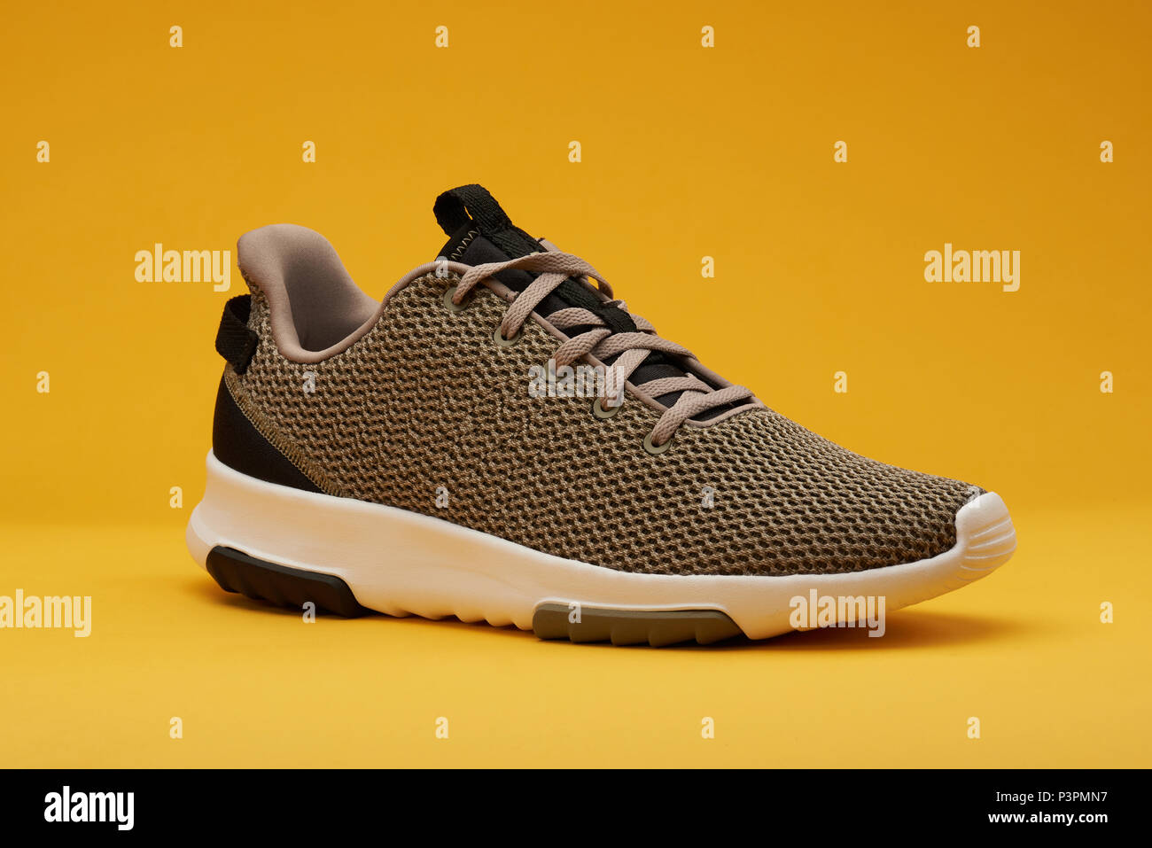 Brown sport shoe for running isolated on yellow background Stock Photo