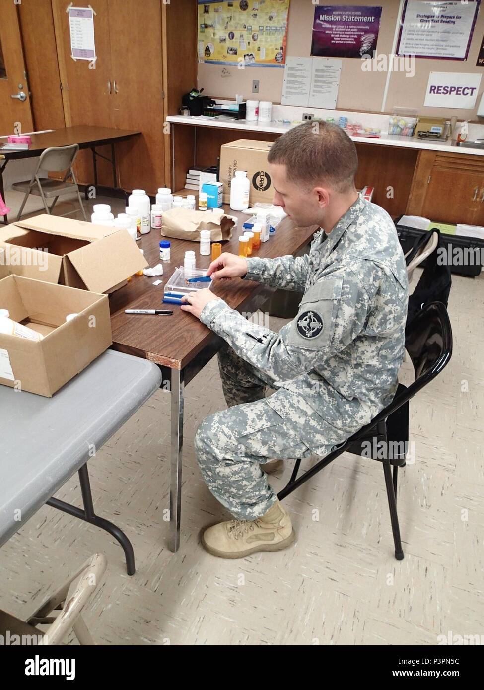 Pfc. Michael Fiedor, a pharmacy technician from Company A, 48th Combat Support Hospital, Fort Story, Va., counts out medication for a patient during Greater Chenango Cares, July 19, 2016.  Greater Chenango Cares is one of the Innovative Readiness Training events which provides real-world training in a joint civil-military environment while delivering world class medical care to the people of Chenango County, N.Y., from July 15-24. Stock Photo