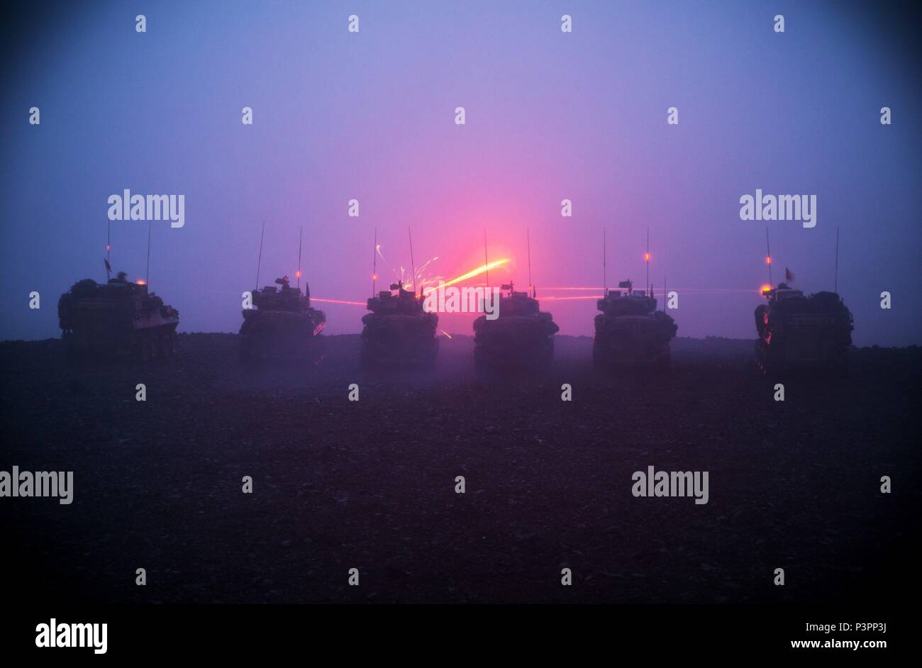 Australian Army Light Armoured Vehicles from the 2nd Cavalry Regiment fire their 25mm chain guns during night firing training for Exercise Rim of the Pacific 2016. (Australian Defence Force photo by Cpl. David Said) Stock Photo