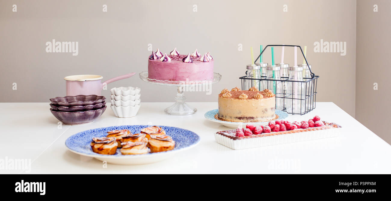 birthday party setting with cakes and pastries Stock Photo