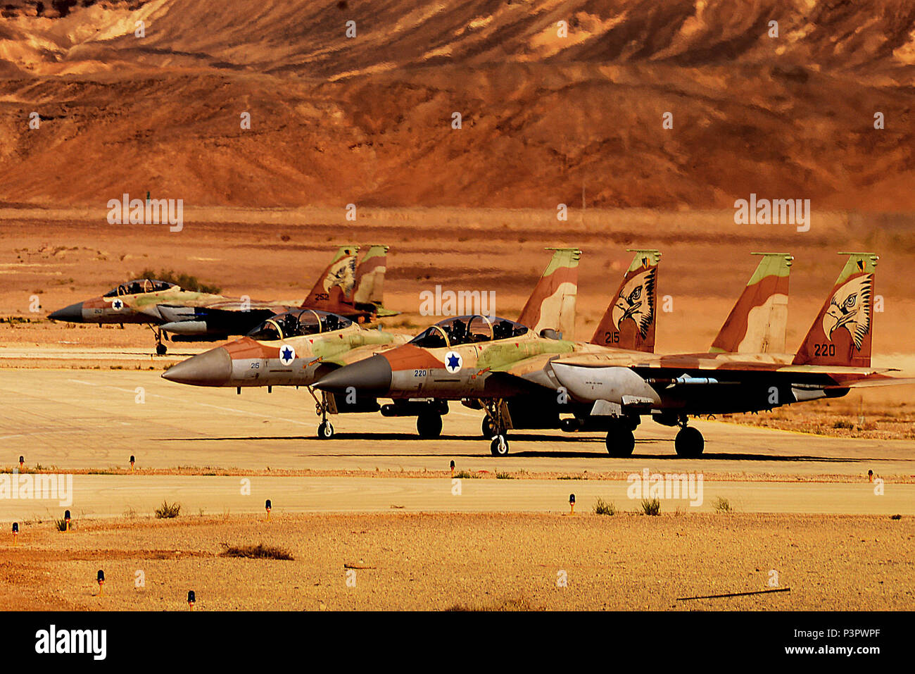 Three F-15I Ra'ams await clearance to launch for a sortie in support of exercise Juniper Falcon May 8, at Uvda Air Base, Israel. Juniper Falcon 17 represents the combination of several bi-lateral component/ Israeli Defense Force exercises that have been executed annually since 2011. These exercises were combined to increase joint training opportunities and capitalize on transportation and cost efficiencies gained by aggregating forces. Stock Photo