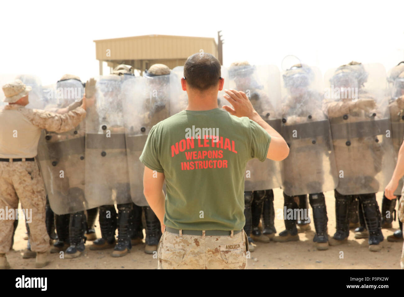 U.S. Marine Corps Cpl. Dustin Anderson, a non-lethal weapons instructor and detainee operations chief with Special Purpose Marine Air-Ground Task Force-Crisis Response-Central Command, observes Marines receive proper shielding techniques during a one-week non-lethal weapons class while forward deployed in the Middle East, May 8, 2017. The training ensures SPMAGTF Marines are prepared to respond to a variety of scenarios that may occur across the USCENTCOM area of operations. SPMAGTF-CR-CC is a well-trained crisis response unit that has the ability to project combat power over vast distances us Stock Photo