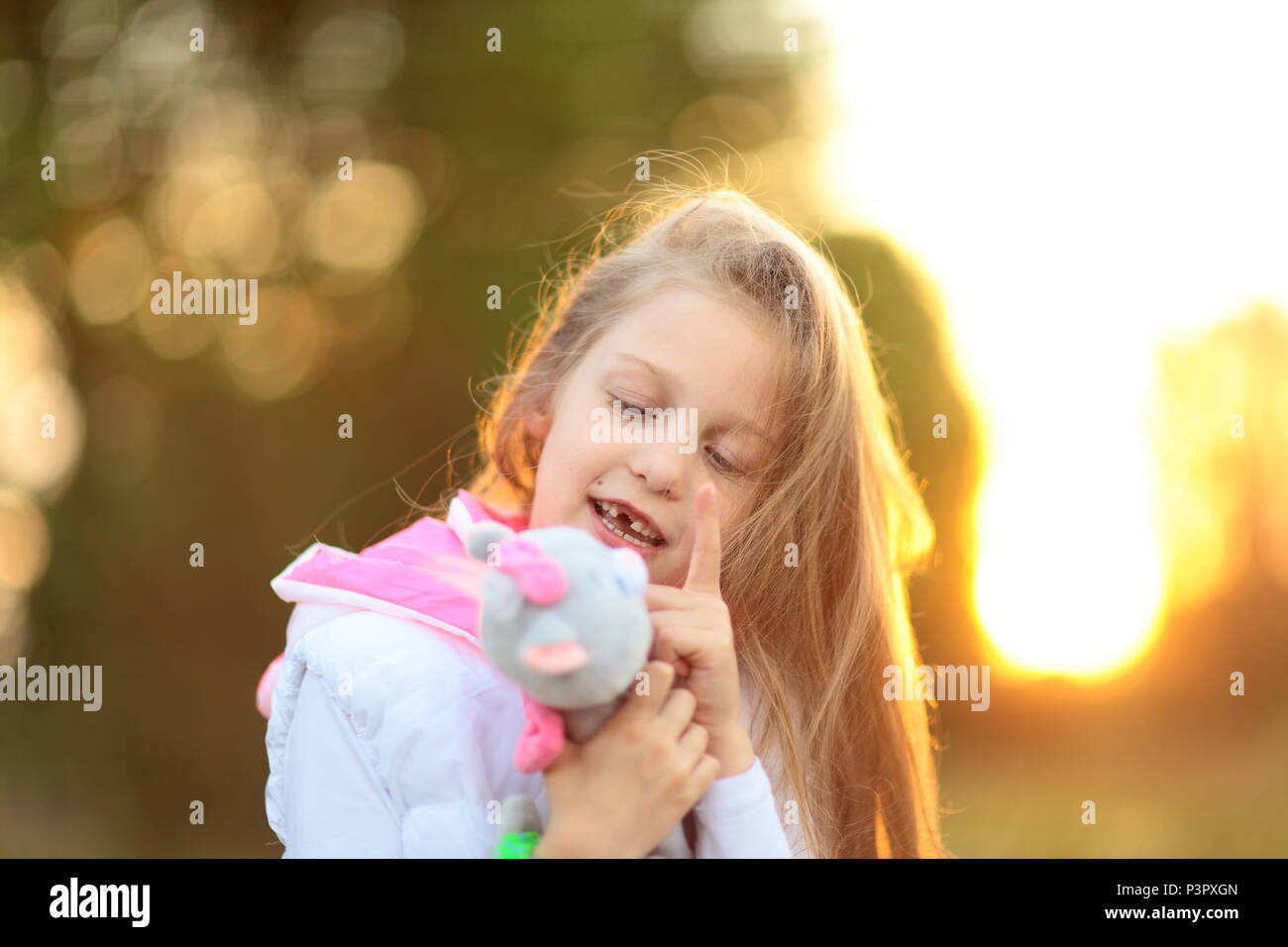 pretty little girl hugging a favorite stuffed animal - a cat for Stock ...