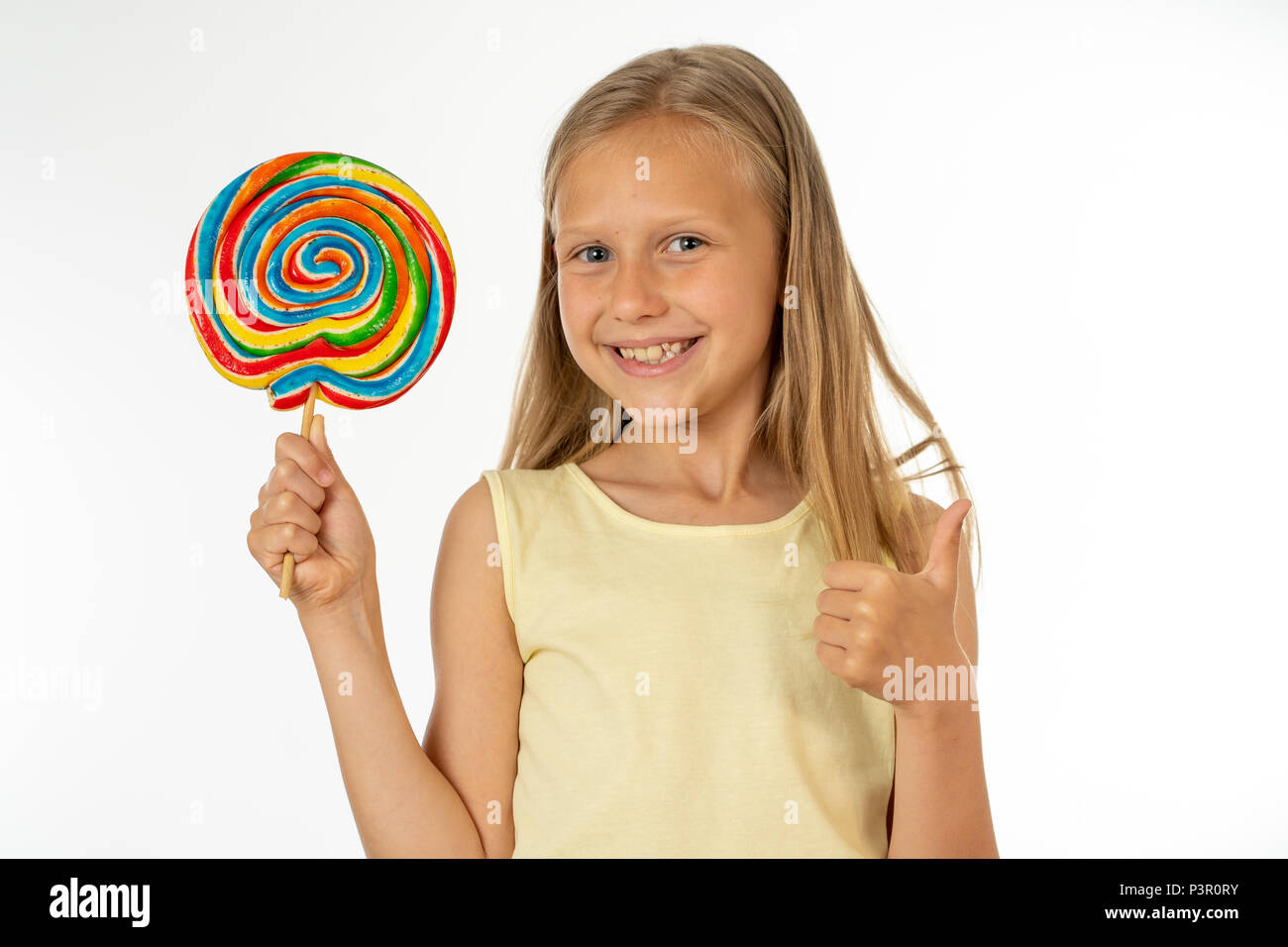 cute happy child with candy lollipop, happy girl eating big sugar lollipop, kid eat sweets. surprised child with candy. isolated on white background,  Stock Photo