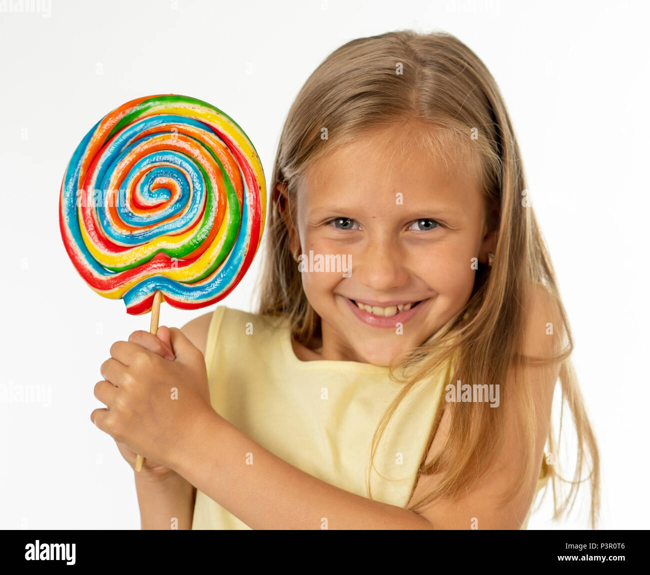 cute happy child with candy lollipop, happy girl eating big sugar lollipop, kid eat sweets. surprised child with candy. isolated on white background,  Stock Photo